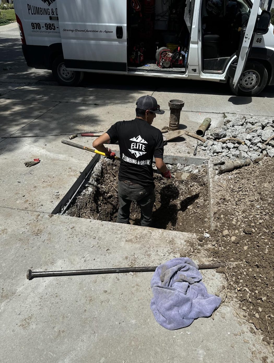 Elite Plumbing & Drains service van at a sewer repair site