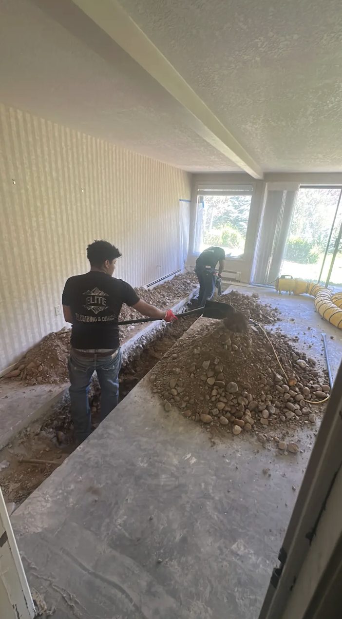 Elite Plumbing & Drains technician trenching a slab for a repipe